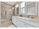 Bathroom featuring a glass shower, double sinks, and modern fixtures at 1004 Sounding Ln, Durham, NC 27703