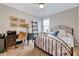 Cozy bedroom with natural light, study desk, and comfortable iron frame bed at 1004 Sounding Ln, Durham, NC 27703