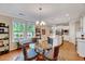Bright dining area with a glass table, hardwood floors, and natural light at 1004 Sounding Ln, Durham, NC 27703