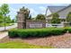 Community entrance sign, showcasing stone accents and well-manicured landscaping at 1004 Sounding Ln, Durham, NC 27703