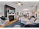 Open-concept living room featuring a cozy fireplace, hardwood floors, and comfortable seating at 1004 Sounding Ln, Durham, NC 27703