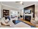 Comfortable living room with a fireplace, hardwood floors, and stylish furniture at 1004 Sounding Ln, Durham, NC 27703