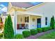 Cozy covered porch with seating, decorative accents, and well-maintained landscaping at 1004 Sounding Ln, Durham, NC 27703