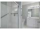 Bright bathroom features a glass-enclosed shower, soaking tub, and white vanity with a lighted mirror at 108-203 Northbrook Dr # 203, Raleigh, NC 27609