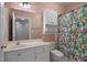 Bathroom with a vanity, a large mirror, cabinets, and a colorful shower curtain at 108-203 Northbrook Dr # 203, Raleigh, NC 27609