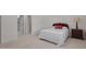 A bright bedroom features a simple bed, a wooden nightstand with a lamp, and an ensuite bathroom at 108-203 Northbrook Dr # 203, Raleigh, NC 27609
