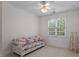 Bedroom featuring a decorative couch by the window and a modern ceiling fan at 108-203 Northbrook Dr # 203, Raleigh, NC 27609