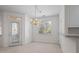 Bright dining area with an elegant chandelier, ample natural light, and access to the outdoor patio at 108-203 Northbrook Dr # 203, Raleigh, NC 27609