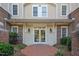 Beautiful building entrance featuring a brick path, charming exterior lighting, and well-maintained landscaping at 108-203 Northbrook Dr # 203, Raleigh, NC 27609