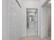 A view of the bathroom through a doorway, showcasing a white vanity and tile flooring at 108-203 Northbrook Dr # 203, Raleigh, NC 27609