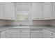 Clean kitchen featuring white cabinetry, laminate countertops and modern appliances at 108-203 Northbrook Dr # 203, Raleigh, NC 27609