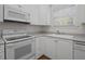 Bright kitchen with white cabinets, modern appliances, laminate countertops and hardwood floors at 108-203 Northbrook Dr # 203, Raleigh, NC 27609