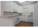 Well-lit kitchen featuring white cabinets, modern appliances, and hardwood flooring at 108-203 Northbrook Dr # 203, Raleigh, NC 27609
