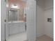 A laundry room with access to an adjacent bathroom that has white vanity and sink at 108-203 Northbrook Dr # 203, Raleigh, NC 27609