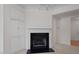 Cozy living room with a black marble fireplace, built-in cabinets, and neutral carpeting at 108-203 Northbrook Dr # 203, Raleigh, NC 27609