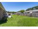 Backyard featuring a well-maintained lawn, a small deck and a full fence at 117 James Dr, Pine Level, NC 27568