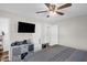 Bedroom with neutral walls, ceiling fan, tv, and an open closet organizer at 117 James Dr, Pine Level, NC 27568