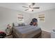 Bedroom with neutral walls, two windows, and ceiling fan at 117 James Dr, Pine Level, NC 27568