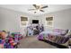 Cozy bedroom featuring a ceiling fan and two windows, with space for play and relaxation at 117 James Dr, Pine Level, NC 27568