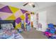 Colorful bedroom featuring a bright accent wall and ample space for toys at 117 James Dr, Pine Level, NC 27568