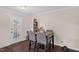 Bright dining area with a stylish table, chairs, and a door to the backyard, perfect for entertaining at 117 James Dr, Pine Level, NC 27568