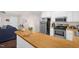 Well-lit kitchen features stainless steel appliances, butcher block counter, and white cabinetry at 117 James Dr, Pine Level, NC 27568