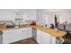 Kitchen view with butcher block counter, stainless appliances, and white cabinetry at 117 James Dr, Pine Level, NC 27568