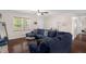 Cozy living room featuring a sectional sofa, hardwood floors, and a bright window providing natural light at 117 James Dr, Pine Level, NC 27568