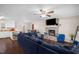 Spacious living room featuring a large sectional sofa, fireplace, and an open layout connecting to the kitchen at 117 James Dr, Pine Level, NC 27568