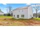 Backyard view of the two-story home with sliding glass doors leading to a concrete patio at 119 Leven Dr, Gibsonville, NC 27249