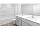 Well-lit bathroom featuring a shower-tub combo and a vanity with dual sinks for convenience at 119 Leven Dr, Gibsonville, NC 27249