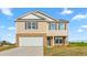 Two-story home featuring a brick and vinyl exterior with gray shutters and a concrete driveway at 119 Leven Dr, Gibsonville, NC 27249