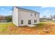 Two-story home showcasing the back facade, with a small concrete patio and ample backyard space at 119 Leven Dr, Gibsonville, NC 27249