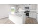 Bright kitchen with gray cabinets, granite countertops, a stainless steel oven, and wood-look flooring at 119 Leven Dr, Gibsonville, NC 27249