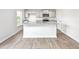 Kitchen featuring an island with granite countertops, gray cabinets, stainless steel appliances, and wood-look floors at 119 Leven Dr, Gibsonville, NC 27249