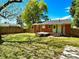 Large grassy backyard with a deck and fence, perfect for outdoor activities at 1206 Downing Rd, Raleigh, NC 27610