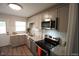 Updated kitchen with stainless steel appliances, light grey cabinets, and granite countertops at 1206 Downing Rd, Raleigh, NC 27610