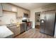 Modern kitchen featuring stainless steel appliances, grey cabinets, granite counters and wood-look flooring at 1206 Downing Rd, Raleigh, NC 27610