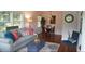 Cozy living room with hardwood floors, a comfortable sofa, and a view into the dining area at 1206 Downing Rd, Raleigh, NC 27610