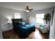 Serene bedroom featuring hardwood floors, two windows, and calming wall decor at 1206 Downing Rd, Raleigh, NC 27610