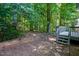 Lush backyard surrounded by mature trees, raised garden, and deck at 125 Chimney Rise Dr, Cary, NC 27511