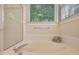 Bathroom featuring a glass shower, soaking tub, and window at 125 Chimney Rise Dr, Cary, NC 27511