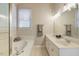 Bathroom featuring a soaking tub, double sink vanity, and natural light at 125 Chimney Rise Dr, Cary, NC 27511