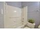 Bright bathroom featuring tiled shower and unique floral wallpaper at 125 Chimney Rise Dr, Cary, NC 27511