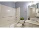 Cozy bathroom featuring a tub, tiled shower, and floral wallpaper at 125 Chimney Rise Dr, Cary, NC 27511