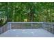 Spacious wooden deck with a view of the lush, wooded backyard at 125 Chimney Rise Dr, Cary, NC 27511