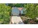 Inviting one-story home showcasing light blue siding, lush landscaping, and an attached garage at 125 Chimney Rise Dr, Cary, NC 27511