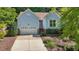 Charming one-story home featuring light blue siding, well-manicured landscaping, and an attached garage at 125 Chimney Rise Dr, Cary, NC 27511