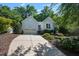 Attractive one-story home with light blue siding, mature trees, landscaping, and attached garage at 125 Chimney Rise Dr, Cary, NC 27511