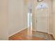 Bright foyer featuring hardwood flooring, an arched doorway, and a stylish light fixture at 125 Chimney Rise Dr, Cary, NC 27511